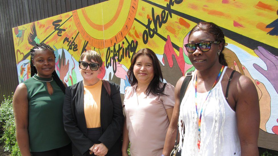 Artists involved in the mural (left to right) Sheila from Cameroon, Sue Bardwell Swindon artist, Patricia from Spain and Clementine from Cameroon standing in front of the painting