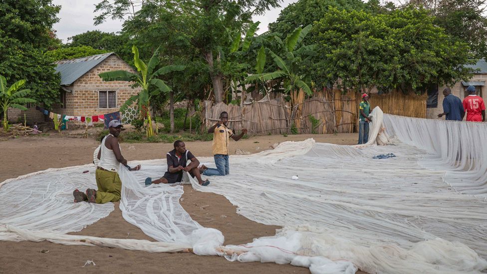 Men in Juma making fishing nets