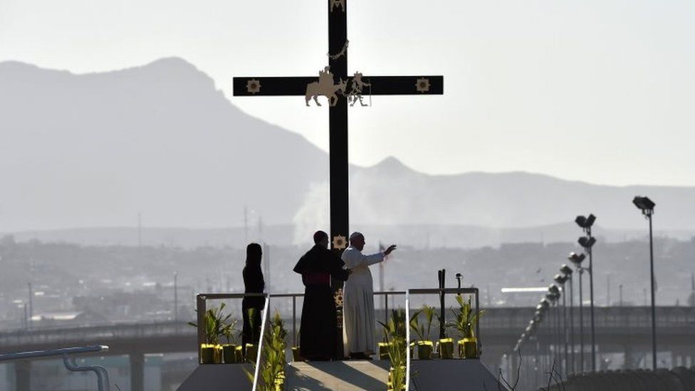 Pope Francis (right) waves from a ramp overlooking the Rio Grande that separates Mexico and the US