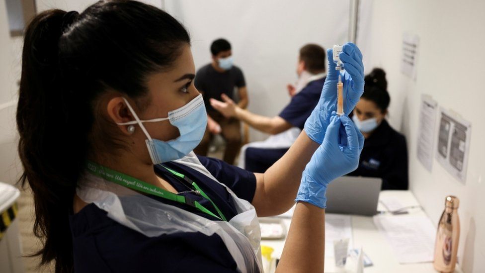 A health worker prepares an injection with a dose of Astra Zeneca coronavirus vaccine