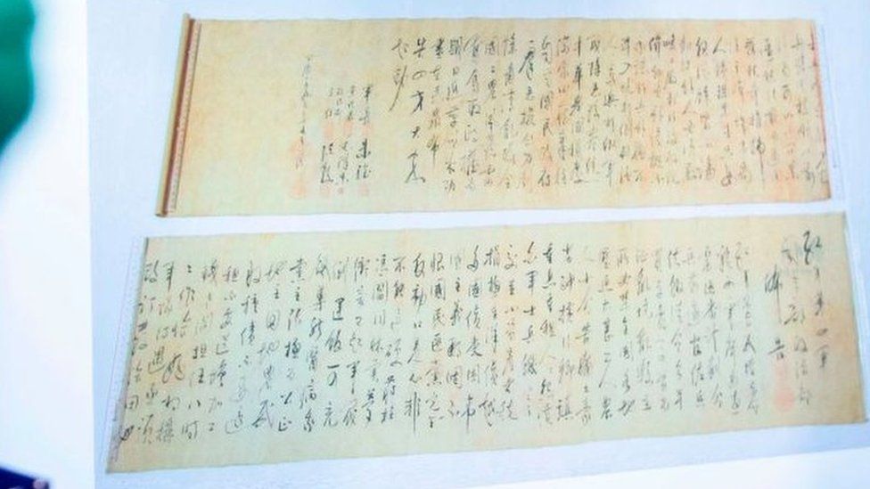 Police show a picture of a calligraphy scroll written by Mao Zedong worth about 300 million USD
