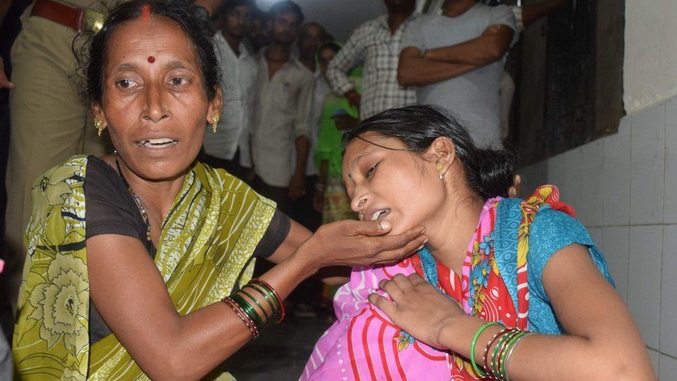 Relatives mourn the death of a children at Baba Raghav Das Hospital in Gorakhpur district of the Indian northern state Uttar Pradesh