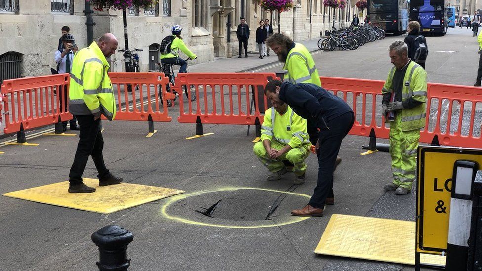 Workmen inspecting the sinkhole on Broad Street