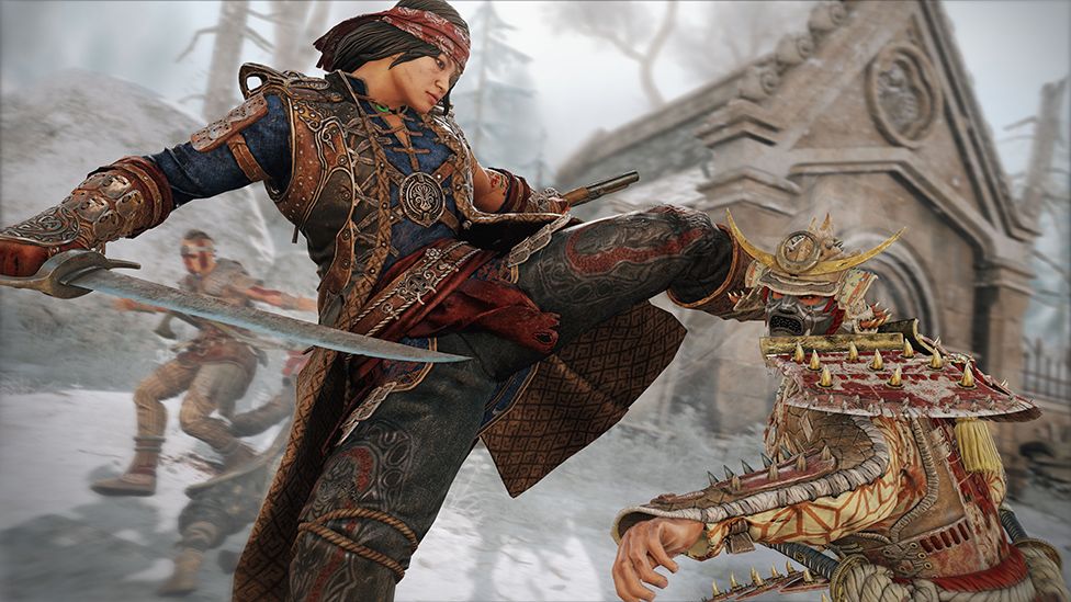 A character holding a large sword and dressed in traditional chinese style military garb/armour attacks a foe with a high kick. The enemy is wearing a horned helmet with silver face mask carved into a monstrous grimace. He's got shoulder pads with sharp-looking gold spikes protruding from it.