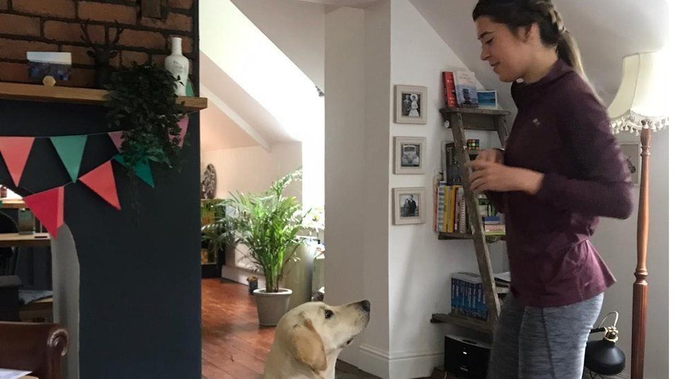 Jenna with trainee dog Una, a yellow Labrador retriever: