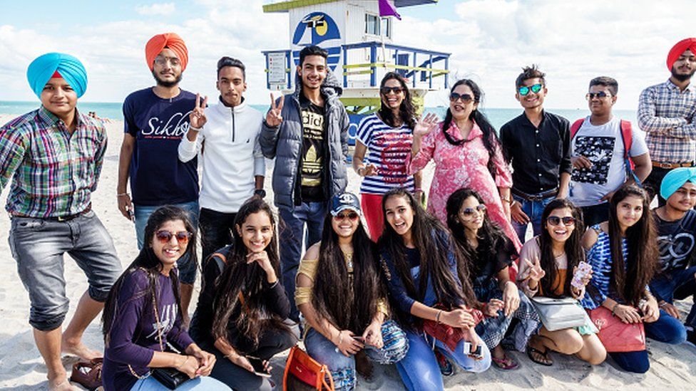 Asian students in group portrait on a beach in Miami, Florida