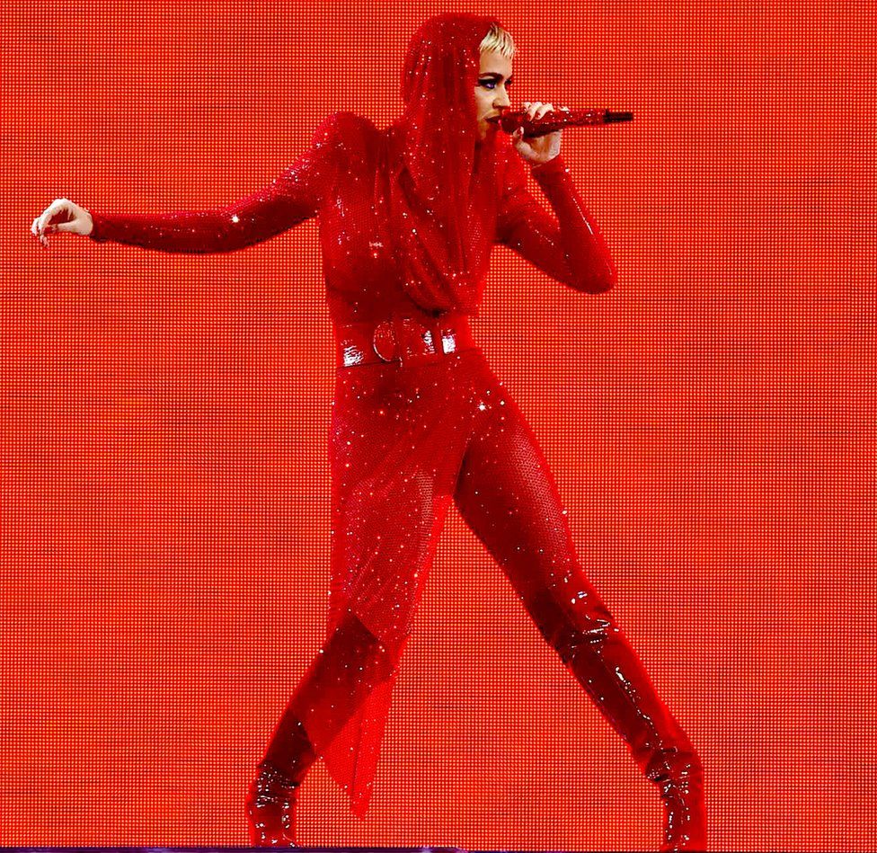 Katy Perry in a bright red outfit from head to toe