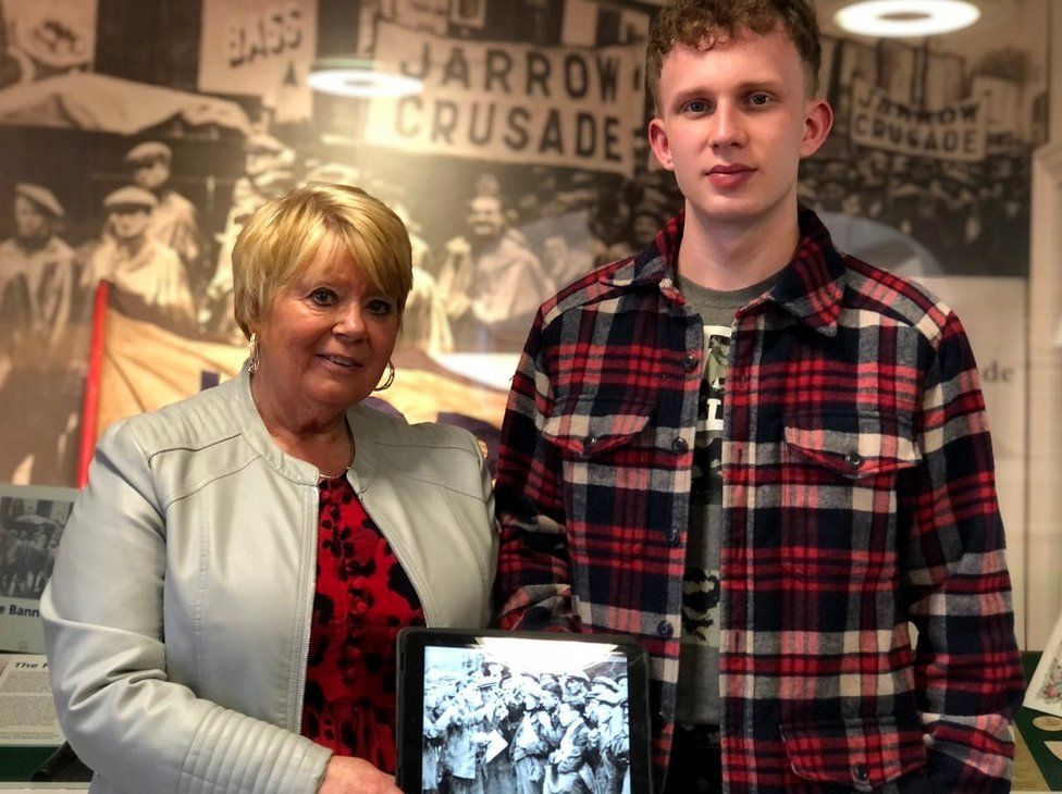 Veronica Andrew and James Lamb hold a picture of their descendant at the Jarrow Crusade exhibition