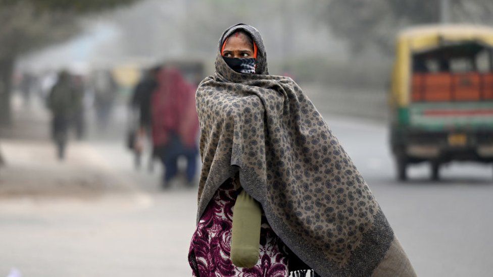 People seen wearing warm clothes on a cold morning at sector 59 on January 4, 2023 in Noida, India. The India Meteorological Department (IMD) has predicted prevalence of severe cold weather conditions, along with dense to very dense fog over northwest India during the next four to five days.