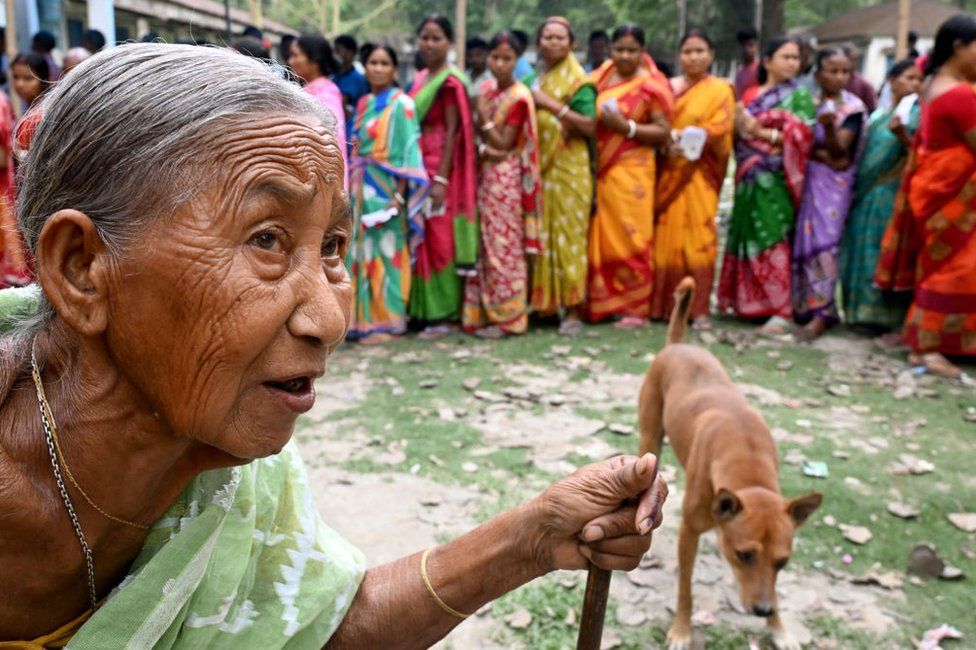 An elderly woman (L) with inked finger leaves a polling booth after casting her ballot to vote in the first phase of India's general election at a polling station in Kalamati village, Dinhata district of Cooch Behar in the country's West Bengal state on April 19, 2024. (Photo by DIBYANGSHU SARKAR / AFP) (Photo by DIBYANGSHU SARKAR/AFP via Getty Images)
