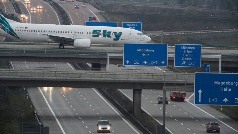 An aircraft crossing a busy motorway at Leipzig-Halle airport
