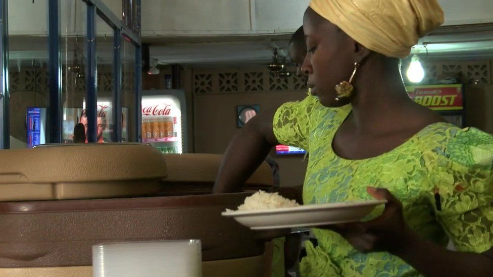 Woman serves rice in a cafe