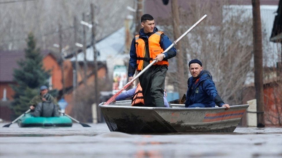 Rescuers ride boats in a flooded street in Orenburg, Russia, 10 April 2024