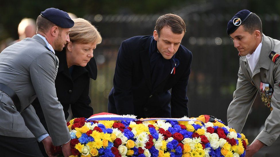 German Chancellor Angela Merkel and French President Emmanuel Macron lay a floral wreath as they take part in a French-German ceremony in the clearing of Rethondes (the Glade of the Armistice) in Compiegne, northern France, 10 November 2018