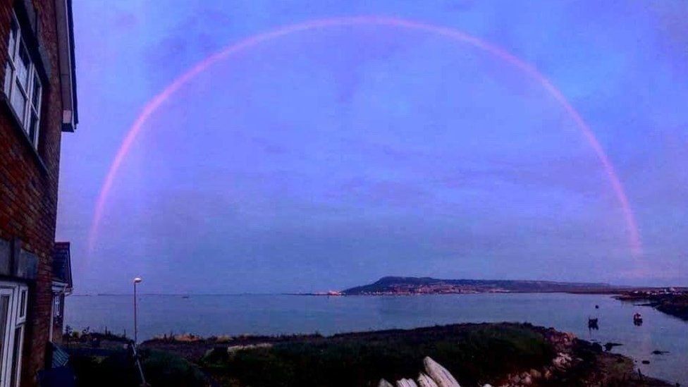 Pink rainbow over Portland, Dorset