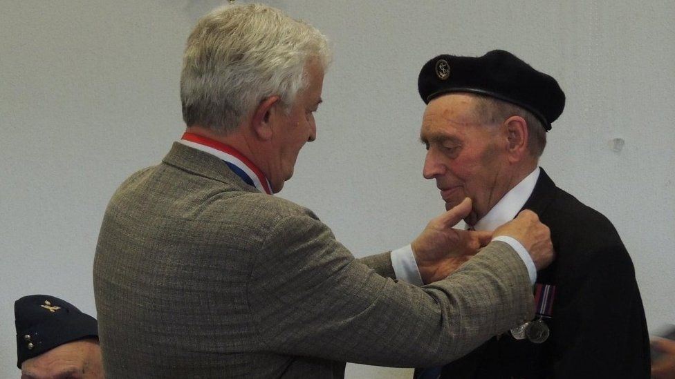 Veteran John Tyler receiving a medal for his time served during World War Two