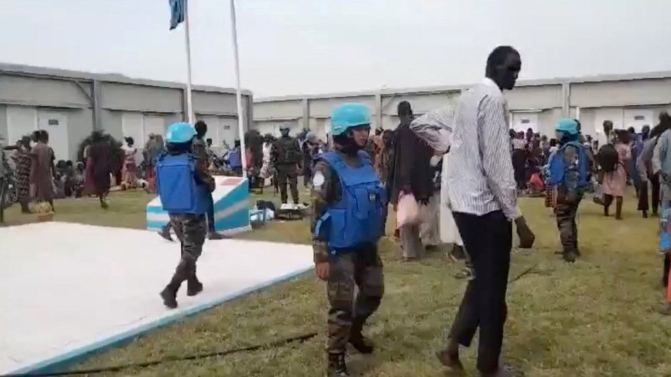 Locals gather at a UN peacekeeper camp following deadly attacks