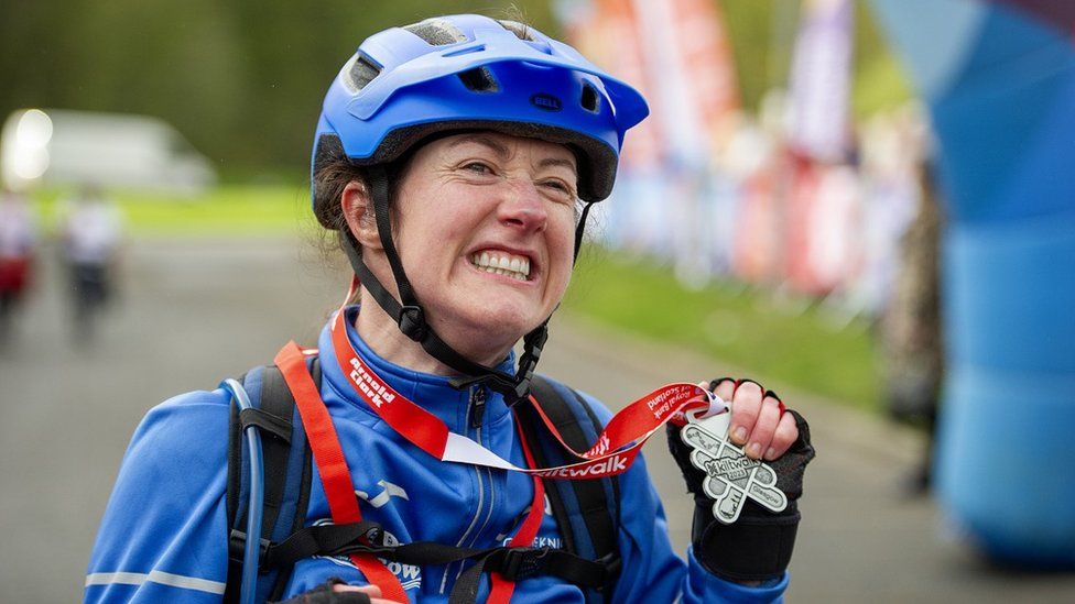 Dr McElroy following Kiltwalk wearing medal