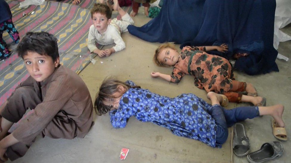 Weary children rest on the floor of a school in Asadabad, Kunar province.