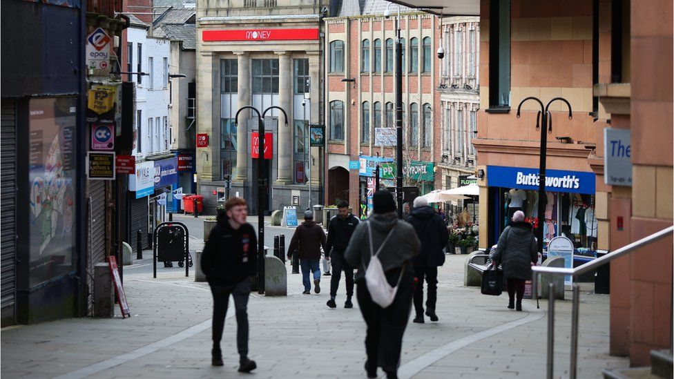 People walk through the town centre in Rochdale, Britain,