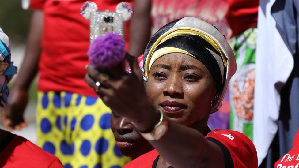 A woman at a rally in Abuja taking a selfie in Abuja, Nigeria - Tuesday 5 December 2017
