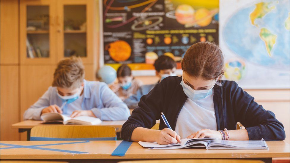 High school students at school, wearing N95 Face masks. - stock photo