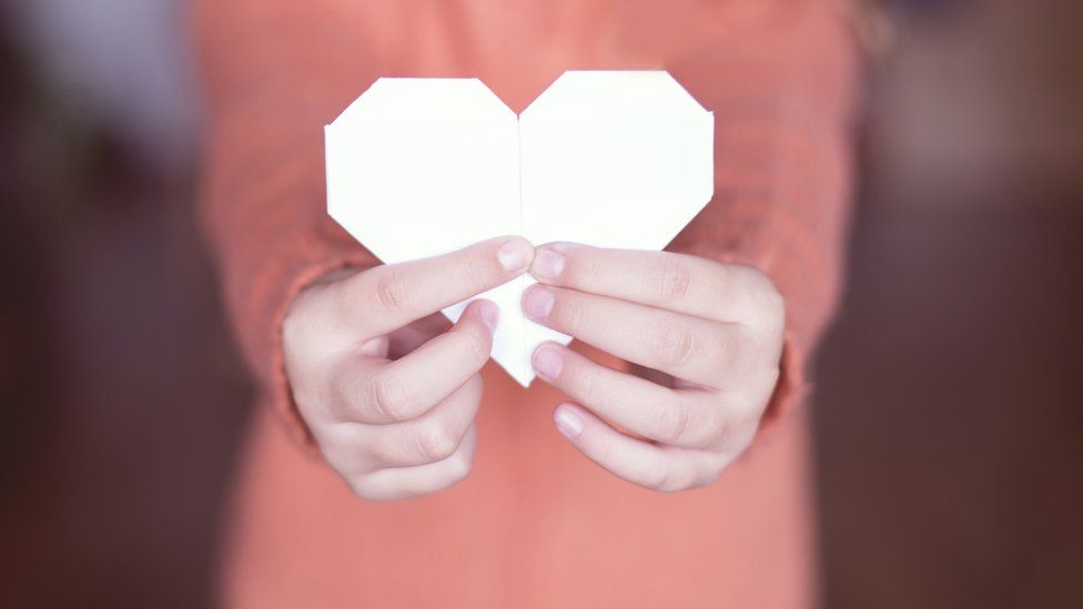 girl-holding-paper-heart.