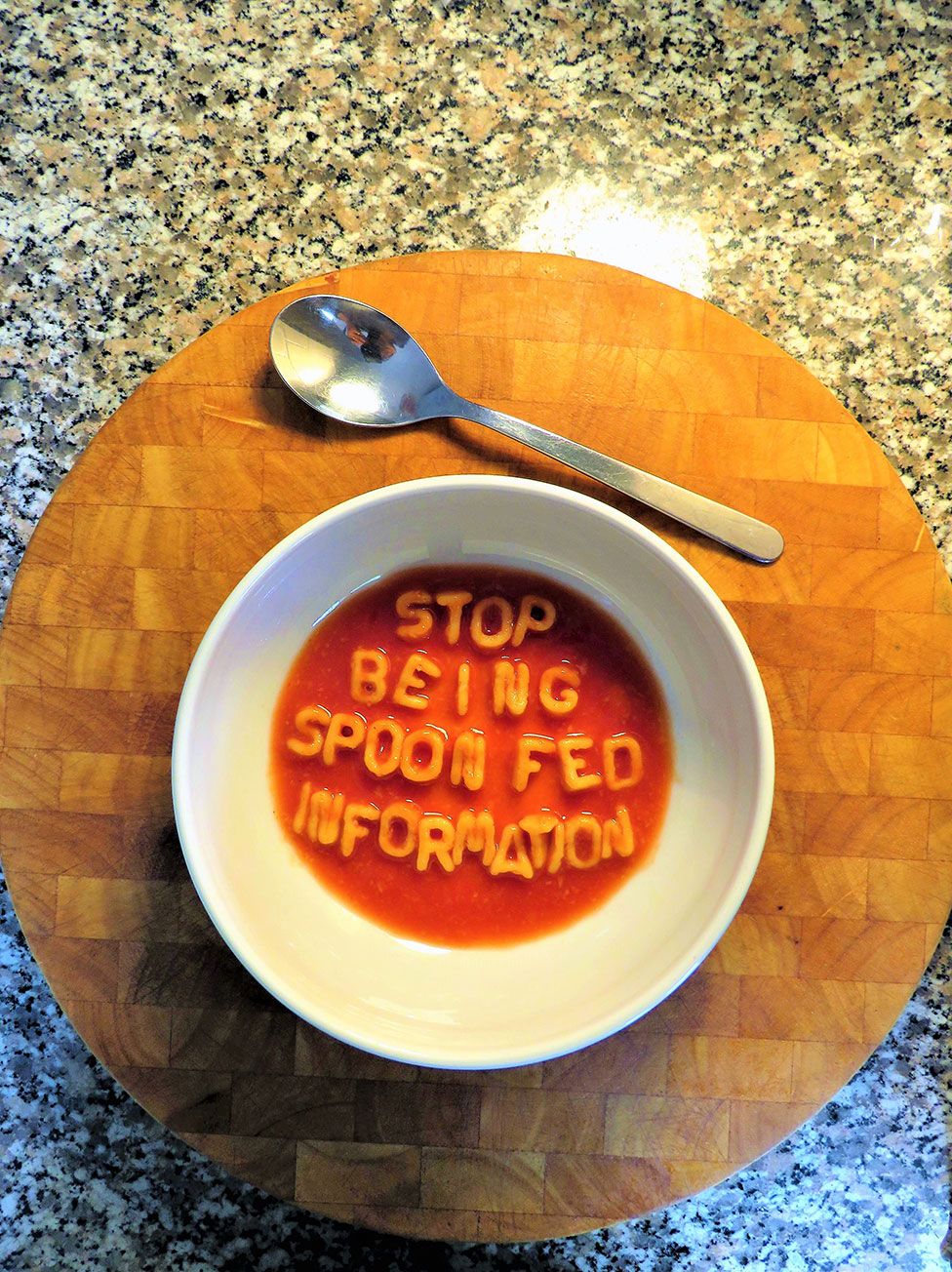 A piece of art showing a bowl of letter spaghetti spelling the words stop being spoon fed information
