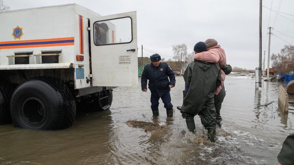 Kazakh rescuers with victim in Pokrovka, North Kazakhstan