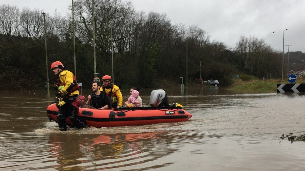 People being helped to safety in a boat in Nantgarw