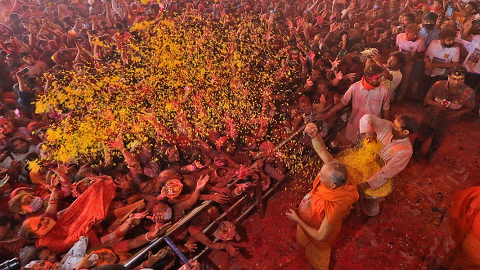 Devotees celebrate with colours, a day before the festival of 'Holi', at Govind Dev Ji Temple, in Jaipur, Rajasthan, India,Thursday, March 17, 2022.