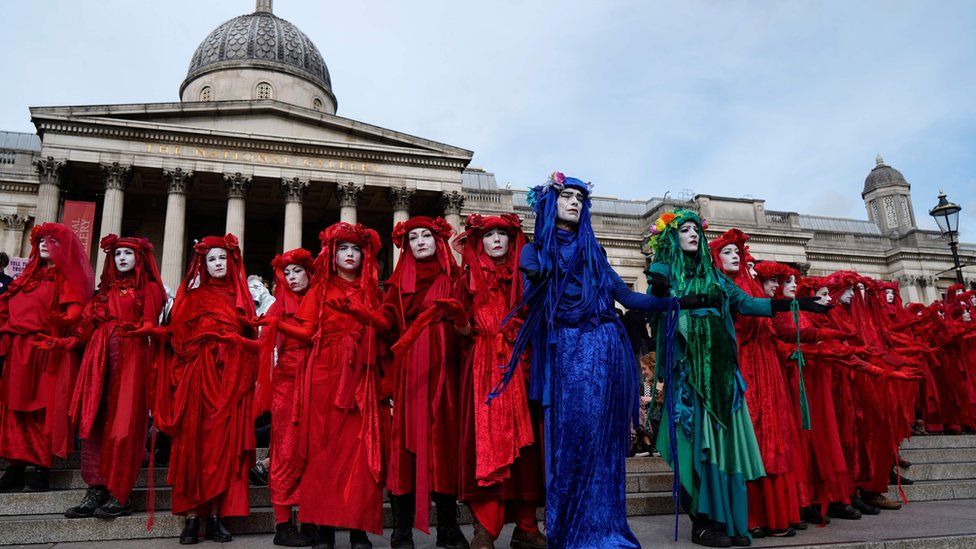 Climate activists protest on the steps of the National Gallery in Trafalgar Square