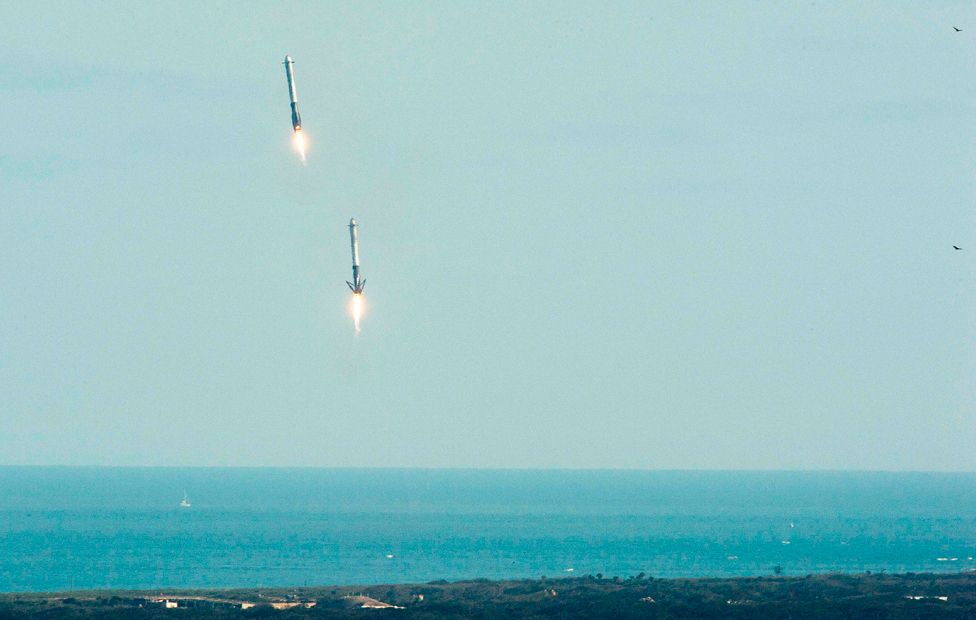 Falcon Heavy's booster rockets descend to land at Florida's Space Coast