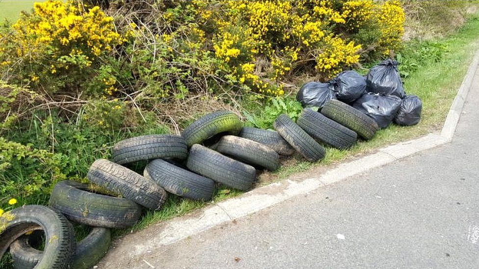 Tyres and bags of collected rubbish