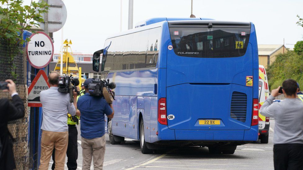 A coach believed to be carrying asylum seekers arriving at Portland Port in Dorset