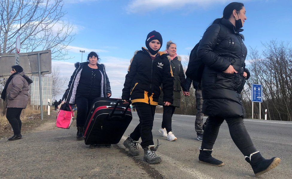 Refugees walk on foot near the Hungarian-Ukrainian border