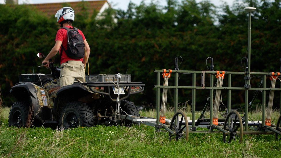 Scientist on a quad bike with equipment attached