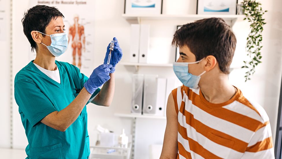 Teen being vaccinated