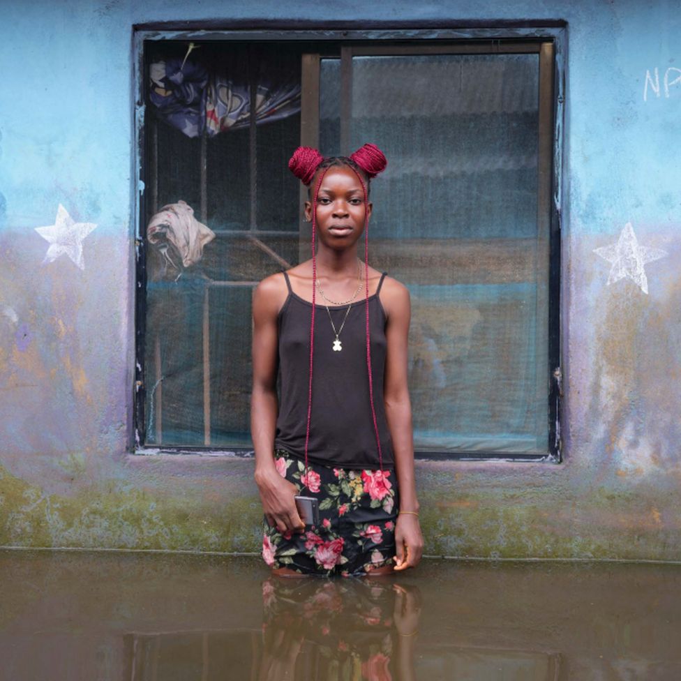 Победительница Одумс стоит в паводковой воде возле своего дома в муниципалитете Огбия, штат Байелса, Нигерия, ноябрь 2022 г.