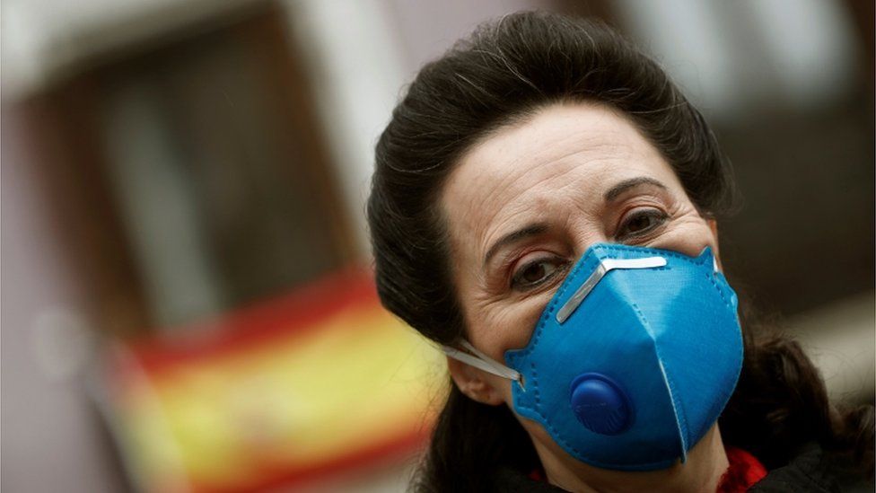 A woman walks on a street in central Madrid, Spain, 10 April 2020