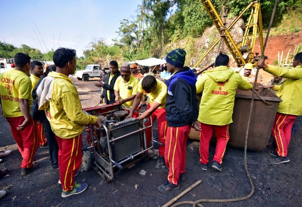 Rescuers prepare a water pump at the site of a coal mine that collapsed in Ksan