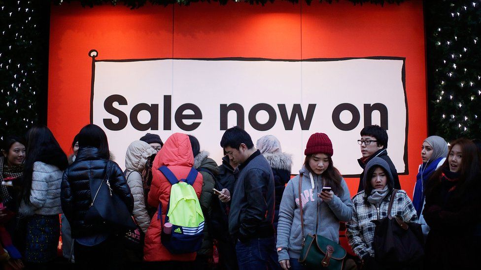 Sale sign, people queuing