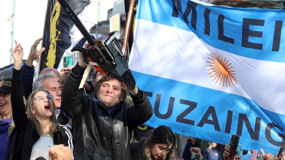 Argentine presidential candidate Javier Milei holds a chainsaw next to Carolina Piparo, candidate for Governor of the Province of Buenos Aires, during a campaign rally, in Buenos Aires, Argentina September 25, 2023.