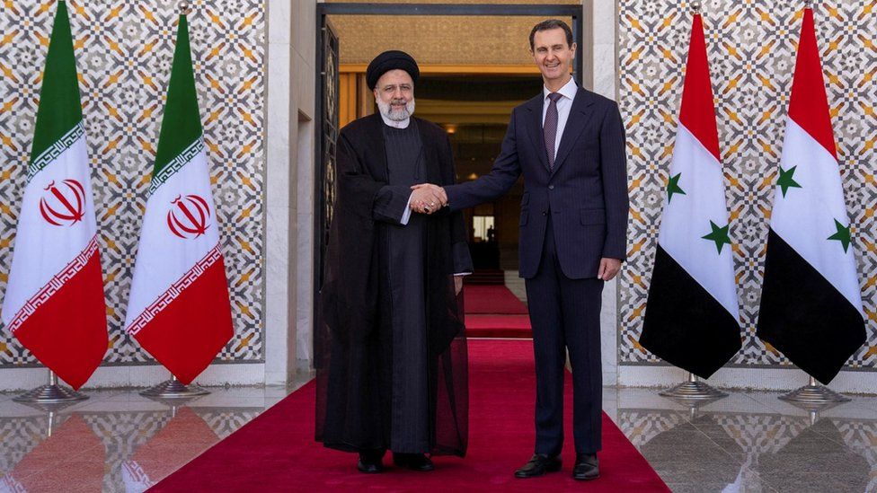 Iranian President Ebrahim Raisi (L) shakes hands with Syrian President Bashar al-Assad (R) during a visit to Damascus, Syria (3 May 2023)