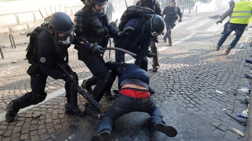 French police detain a protester in Paris. Photo: 16 March 2019
