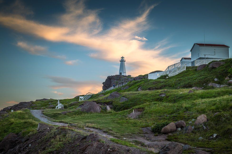 Path leading to a white lighthouse