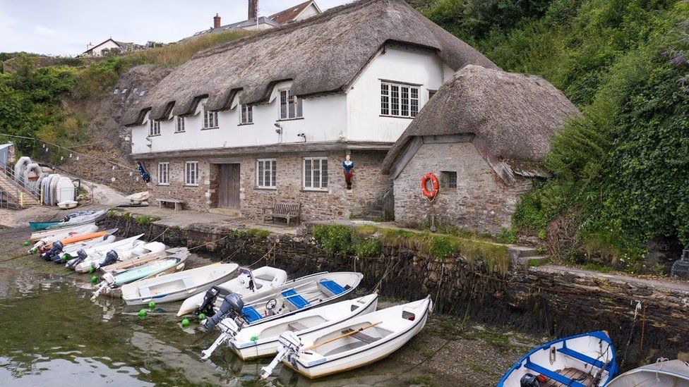 Historic boathouse with boats in quay