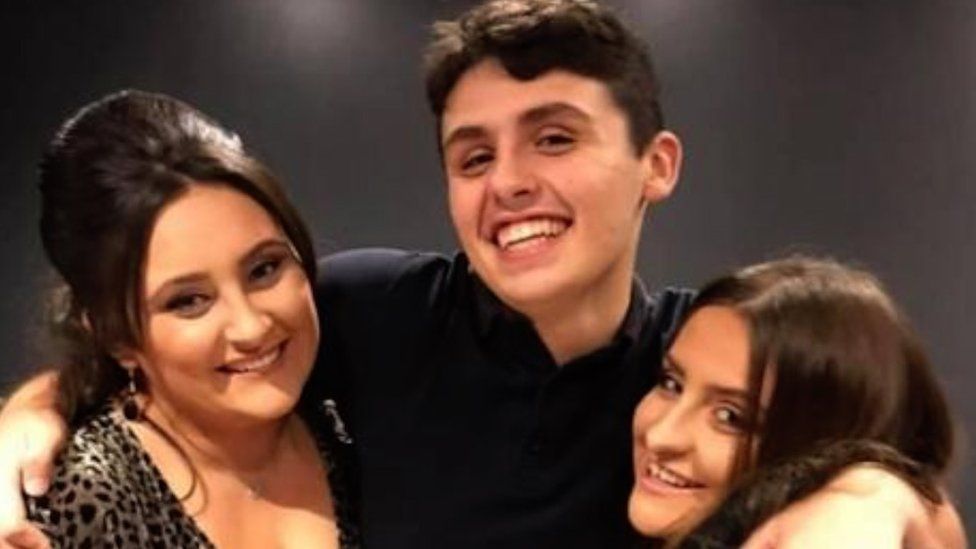 Dylan Price with his two sisters