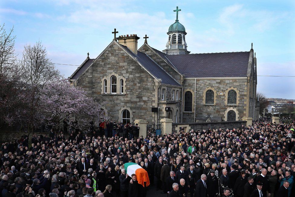 The funeral cortege leaves St Columba's Church and makes it way to Derry City Cemetery on 23 March 2017 in Londonderry-Derry, Northern Ireland.