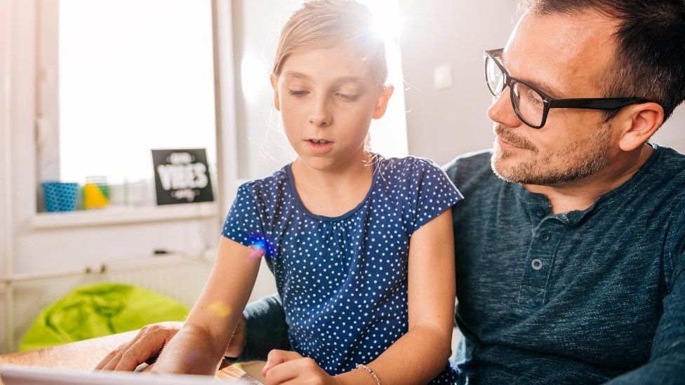 Father with daughter and tablet